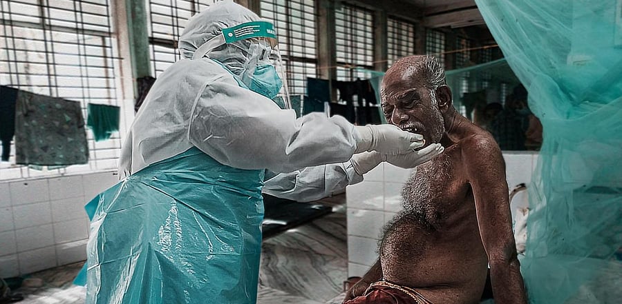 Nurse Stephy Simon feeding aged Covid-19 patient. Credit: Suhail Sani.