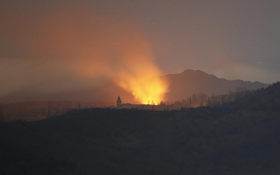 Bursts of explosions, smoke and flame are seen during fighting between Armenian and Azerbaijan's forces near the Holy Savior Cathedral in Shushi, outside Stepanakert, the separatist region of Nagorno-Karabakh, Saturday, Nov. 7, 2020. Fighting over the separatist territory of Nagorno-Karabakh has continued for weeks, with Armenian and Azerbaijani forces blaming each other for new attacks. Credit: AP/PTI Photo