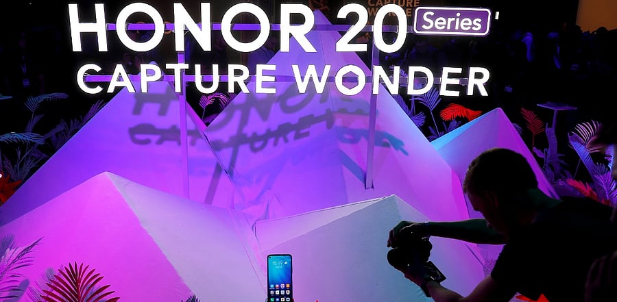 A visitor to the launch of Huawei's Honor 20 range of smartphones photographs the product at an event in London. Credit: Reuters Photo