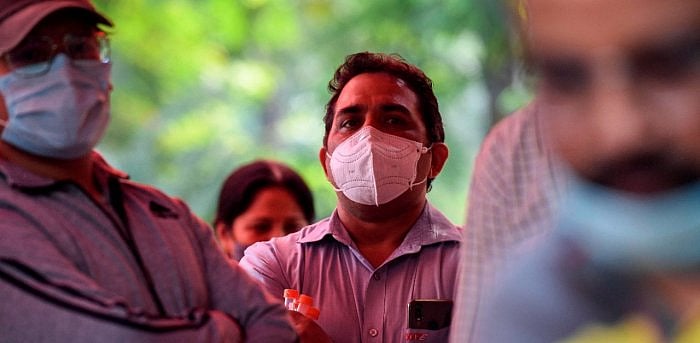 Residents wait to give their swab samples for a RT-PCR Covid-19 test. Credit: AFP Photo