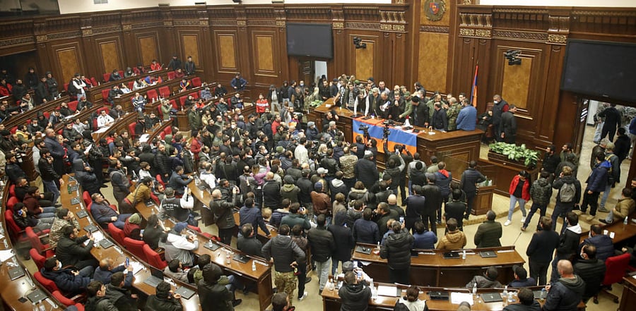 Protesters listen to a speaker as they broke into the parliamentary building protesting against an agreement to halt fighting over the Nagorno-Karabakh region, in Yerevan, Armenia. Credit: AP Photo