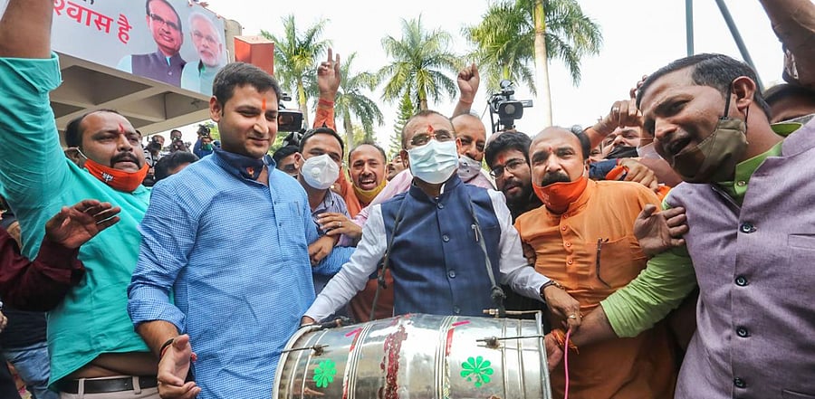 BJP State President VD Sharma and party supporters react during counting day of Madhya Pradesh Assembly bypolls, in Bhopal. Credit: PTI Photo