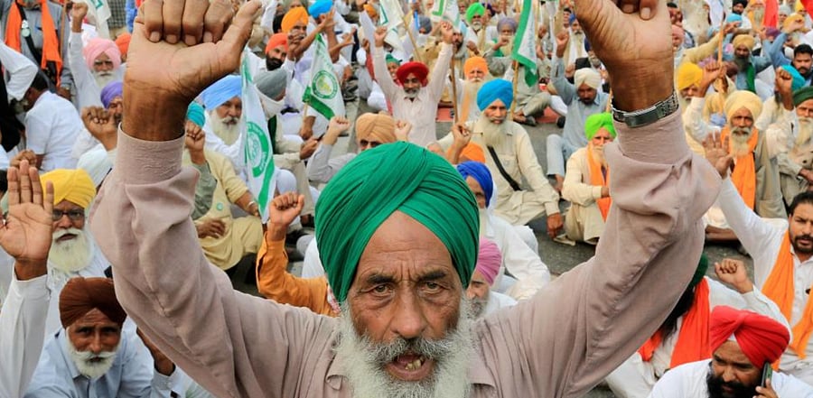 Farmers raise slogans as they block a road at Bhai Kanhaiya Chowk during a protest over the recent farm reform bills, in Bathinda, Thursday, Nov. 5, 2020. Credit: PTI Photo