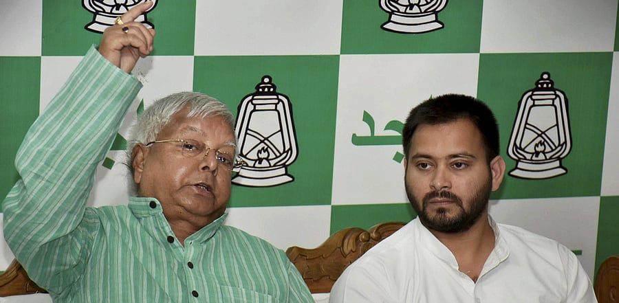 RJD supremo Lalu Prasad addressing a press conference with Grand Alliance CM candidate Tejashwi Yadav. Credit: PTI File Photo