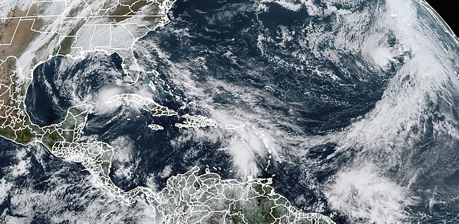 Tropical Storm Eta in the Gulf of Mexico, Theta, right, and a tropical wave to the south that forecasters say has a good chance of becoming Tropical Storm Iota. Credit: AP Photo