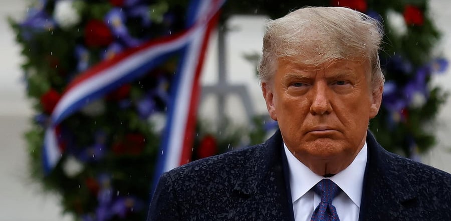 US President Donald Trump turns after placing a wreath at the Tomb of the Unknown Solider as he attends a Veterans Day observance in the rain at Arlington National Cemetery in Arlington. Credit: Reuters