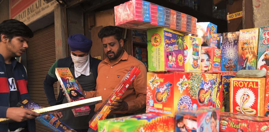 People buy fireworks and crackers ahead of Diwali, the Hindu festival of lights, at a shop in Amritsar. Credit: AFP Photo