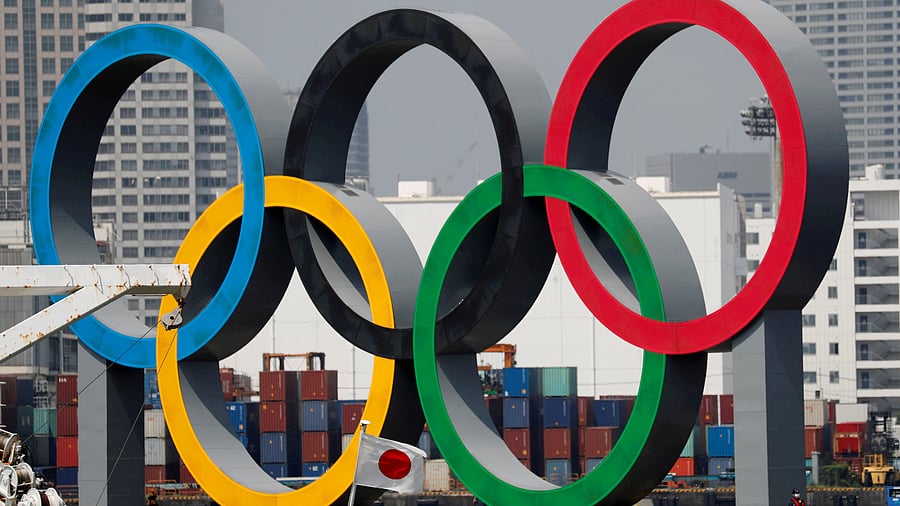 The giant Olympic rings are seen behind Japan's national flag amid the coronavirus disease (Covid-19) outbreak. Credits: Reuters Photo