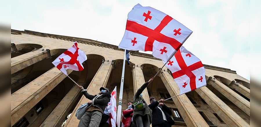 Georgian opposition supporters wave the national flag during a rally in central Tbilisi on November 14, 2020. Credit: AFP Photo