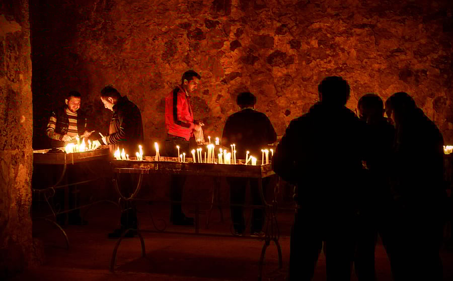 Armenian soldiers light candles as they pay a final tribute to comrades fallen during the military conflict between Armenia and Azerbaijan over the breakaway region of Nagorno-Karabakhat the Orthodox Dadivank Monastery on the outskirts of Kalbajar. Credits: AFP Photo