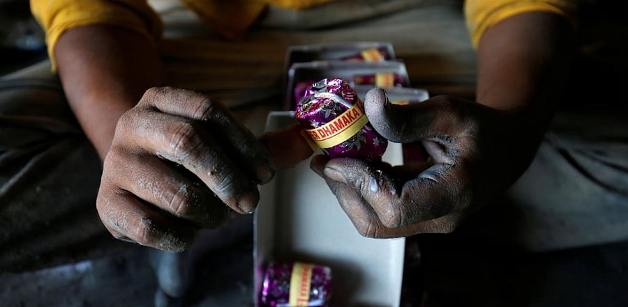 Worker makes firecrackers at a factory ahead of Diwali, the Hindu festival of lights. Credit: Reuters