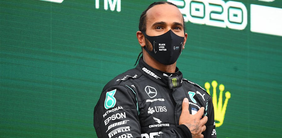 Mercedes' Lewis Hamilton celebrates on the podium after winning the race and the world championship/ Credit: Reuters Photo