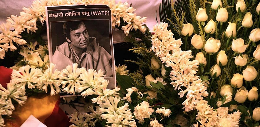 Soumitra Chatterjee's picture is seen on garlands. Credit: AFP Photo