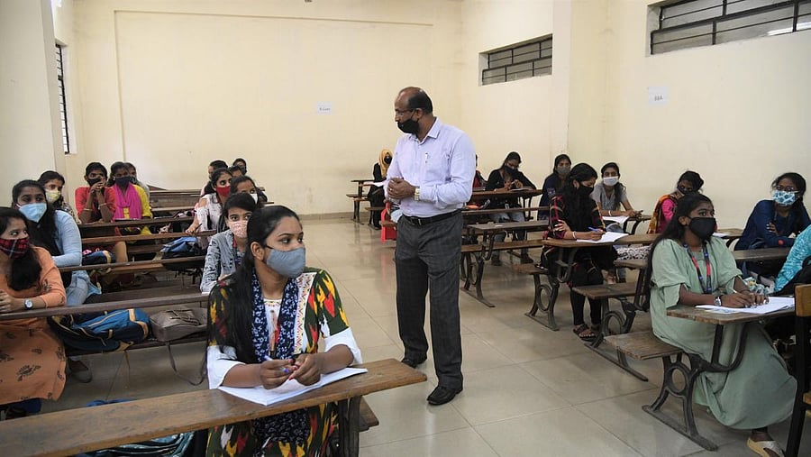 Students of Maharani College attend a class after authorities allowed reopening of the degree colleges, in Bengaluru on Tuesday. Credit: DH Photo/B H Shivakumar
