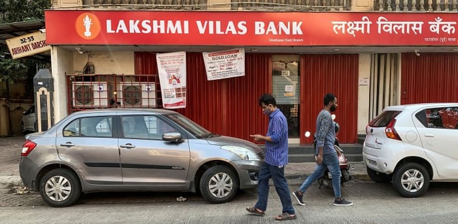 People walk past a Lakshmi Vilas Bank branch in Mumbai, India. Credit: Reuters Photo
