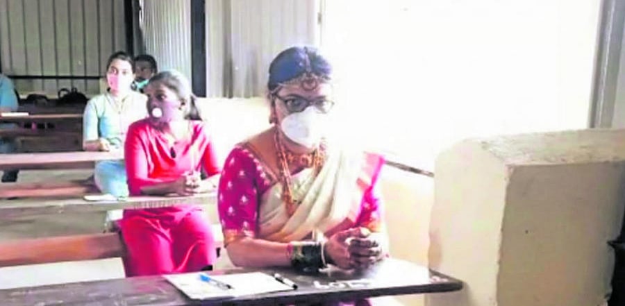 Swathi, the bride, takes the competitive examination at the examination centre in Junior College, Madikeri, on Sunday.