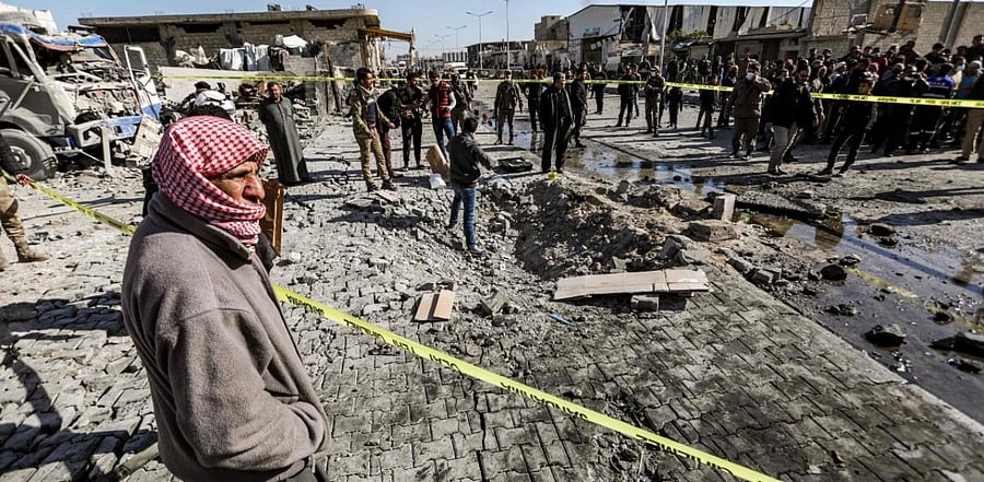 People inspect the scene of a car bomb in the Turkish-controlled town of al-Bab in the north of Syria's Aleppo province. Credit: AFP.