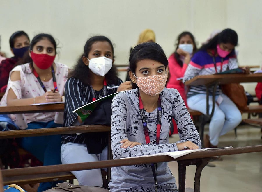 Students attend a class after authorities allowed reopening of colleges, in Bengaluru. PTI