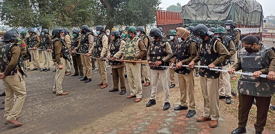 Police make a human barricade to stop various farmer organisations during a protest march against the farm reform bills, in Hisar district. Credit: PTI Photo