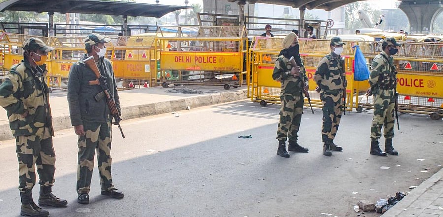 Police stand guard as farmers march towards Delhi during 'Delhi Chalo' protest over the farm reform bills, at Badarpur border in Faridabad. Credit: PTI Photo