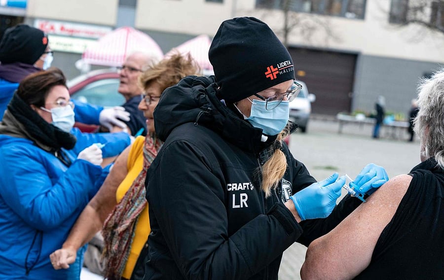 Nurses inject the vaccine against influenza to high-risk patients, outdoors to prevent the spread of the coronavirus disease, in Trelleborg, southern Sweden. Credit: AFP