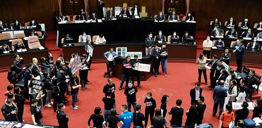 Legislators from the main opposition Kuomintang (KMT) display placards reading “feed people with Ractopamine pork" to ask Premier Su Tseng-chang to step down during a demonstration at the Parliament in Taipei. Credit: AFP Photo