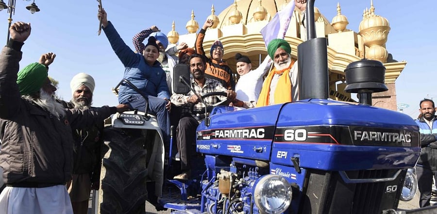 Farmers sit on a tractor as they shout slogans before leaving for Delhi to protest against the central government's recent agricultural reforms, on the outskirts of Amritsar. Credit: AFP.