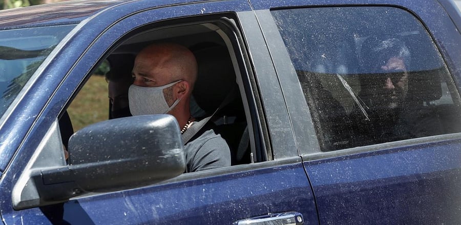 Argentina's Gimnasia y Esgrima substitute coach Sebastian Mendez (L) leaves the Casa Rosada government house. Credit: AFP Photo