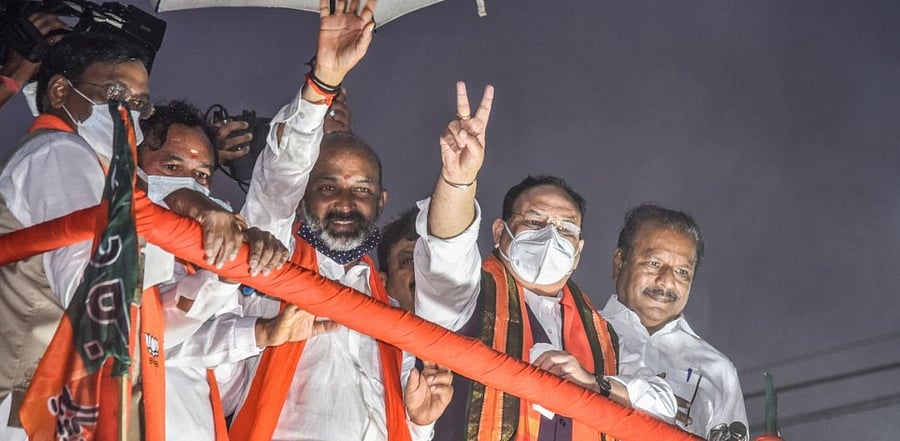BJP National President J P Nadda with Minister of State for Home Affairs G Kishan Ready and State BJP President Bandi Sanjay during a roadshow as part of GMC election campaign, in Hyderabad. Credit: PTI.