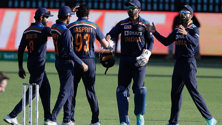 India's Jasprit Bumrah, centre, is congratulated by teammates after taking the wicket of Australia's Aaron Finch during the one day international cricket match between India and Australia at the Sydney Cricket Ground. Credit: AP Photo