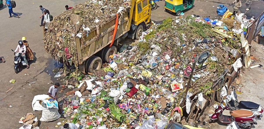 Bescom staff who visit households every month to give electricity bill will also bill for waste disposal services. Credit: DH Photo