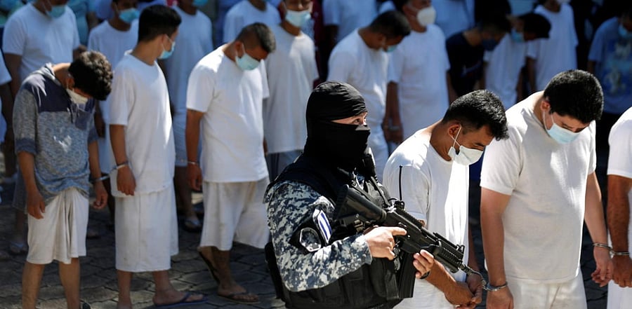 Handcuffed suspected gang members are presented to the media after being arrested by police. Credit: Reuters Photo