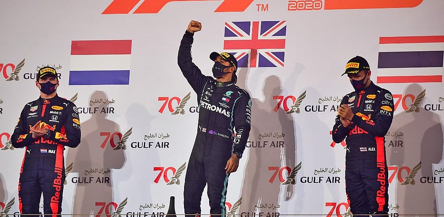 Mercedes' British driver Lewis Hamilton (C) celebrates on the podium after winning the Bahrain Formula One Grand Prix at the Bahrain International Circuit. Credit: AFP Photo
