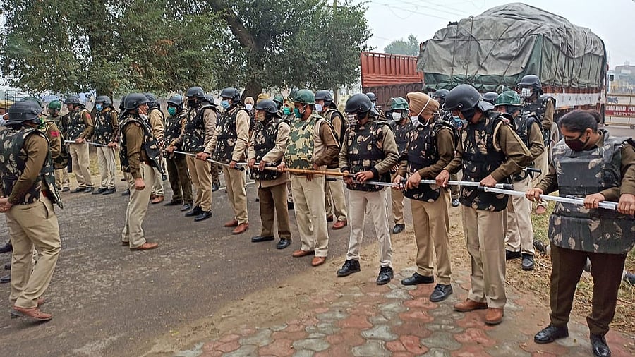 Police make a human barricade to stop various farmer organisations during a protest march against the farm reform bills, in Hisar district. Credit: PTI Photo