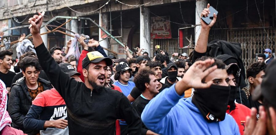 Anti-government demonstrators chant slogans during a protest near Habboubi Square in Iraq's southern city of Nasiriyah in Dhi Qar province on November 29, 2020. Credit: AFP Photo