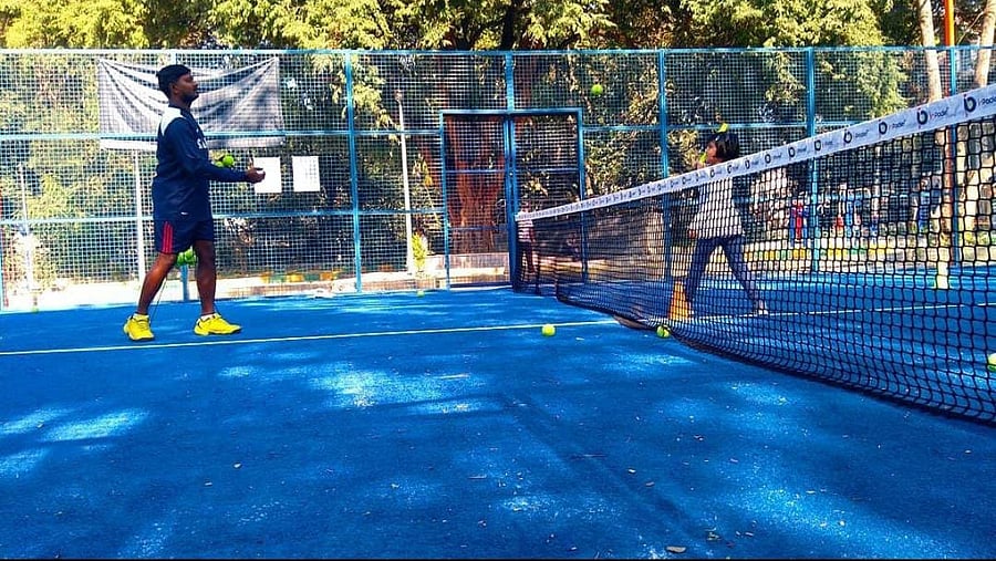 Padel coach DB Santosh (left) putting a young player through the paces.