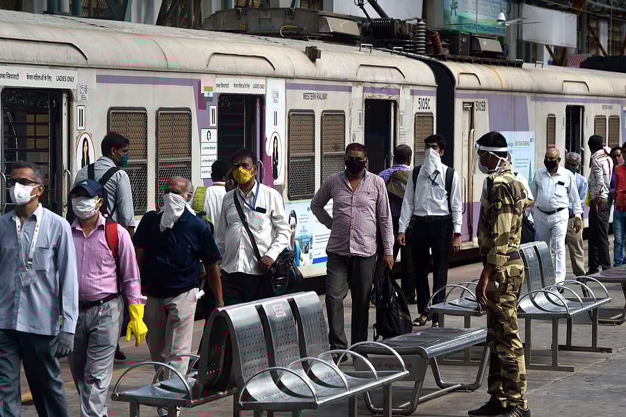 Passengers walk in a platform as they arrive with a train scheduled for essential service workers after the government eased a nationwide lockdown imposed as a preventive measure against the COVID-19 coronavirus. Credits: AFP Photo
