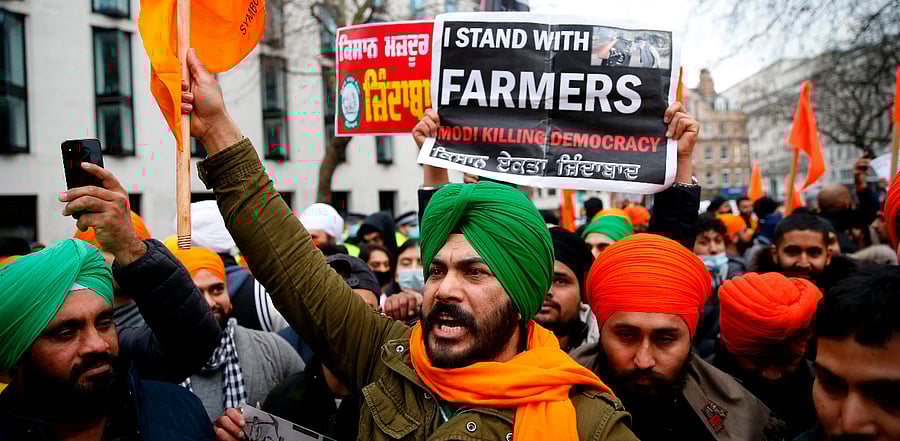 Protesters hold up placards as the gather outside the Indian High Commission in central London. Credit: AFP Photo