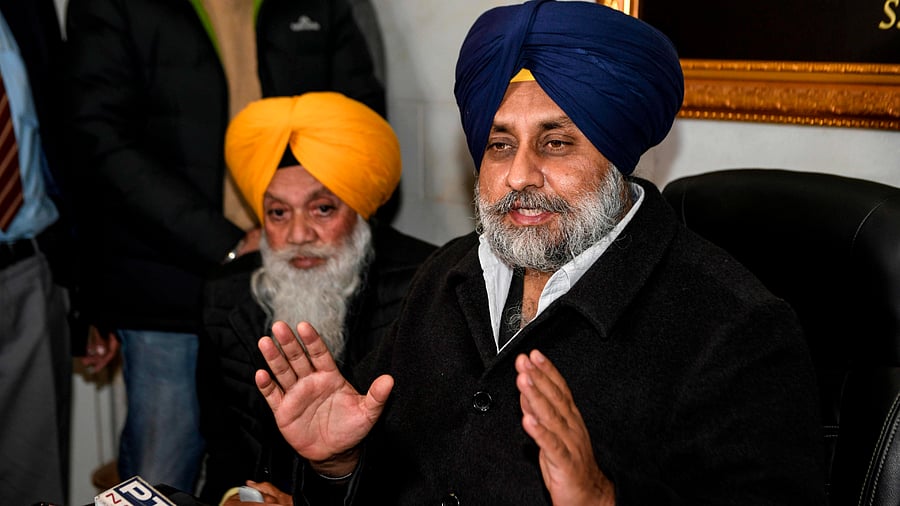 Shiromani Akali Dal (SAD) party President Sukhbir Singh Badal (R) speaks to media representatives. Credit: AFP Photo