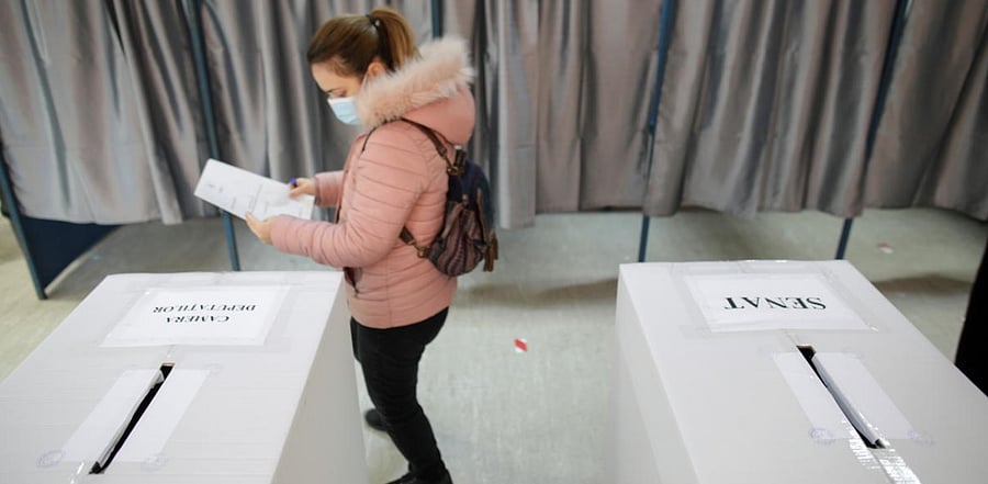 An woman prepares to cast her ballot for the legislative election, in Bucharest, Romania, December 6, 2020. Credit: Inquam Photos/Octav Ganea/Reuters.