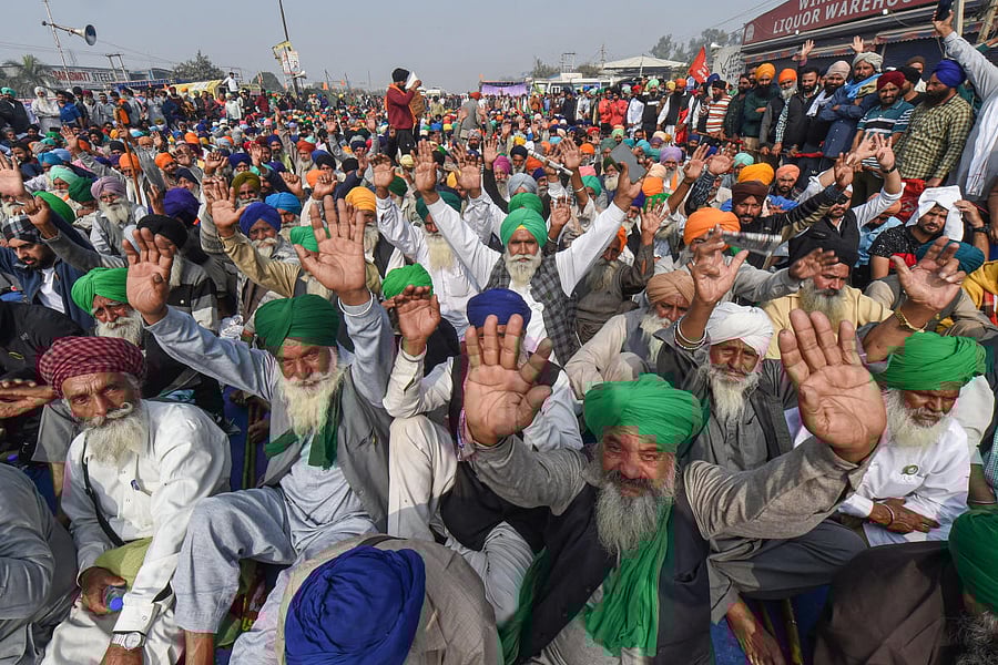 Farmers raise slogans during their agitation against the Center's new farm laws, at Singhu border in New Delhi. Credit: PTI Photo.