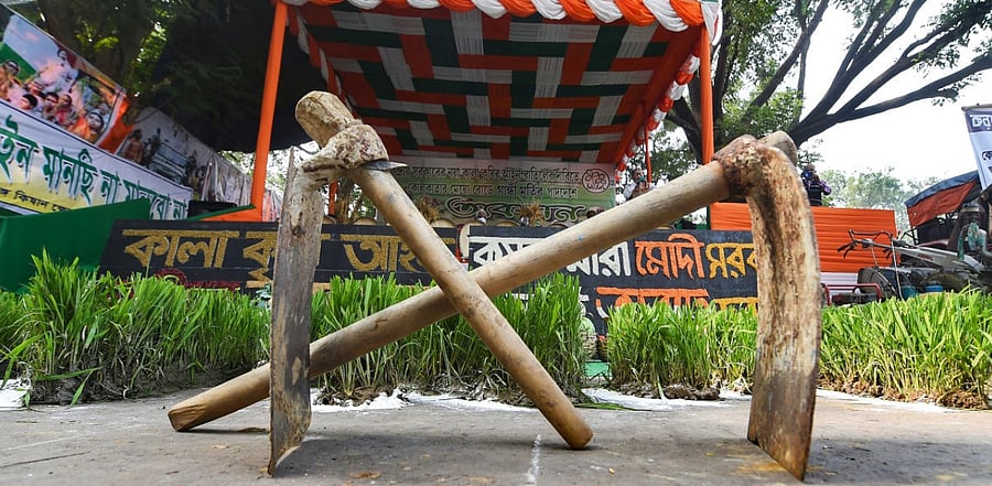 Farming tools at the site of a sit-in protest by Trinamool Congress in support of the nationwide strike, called by farmers to press for repeal of the Centre's agri laws, in Kolkata. Credit: PTI Photo