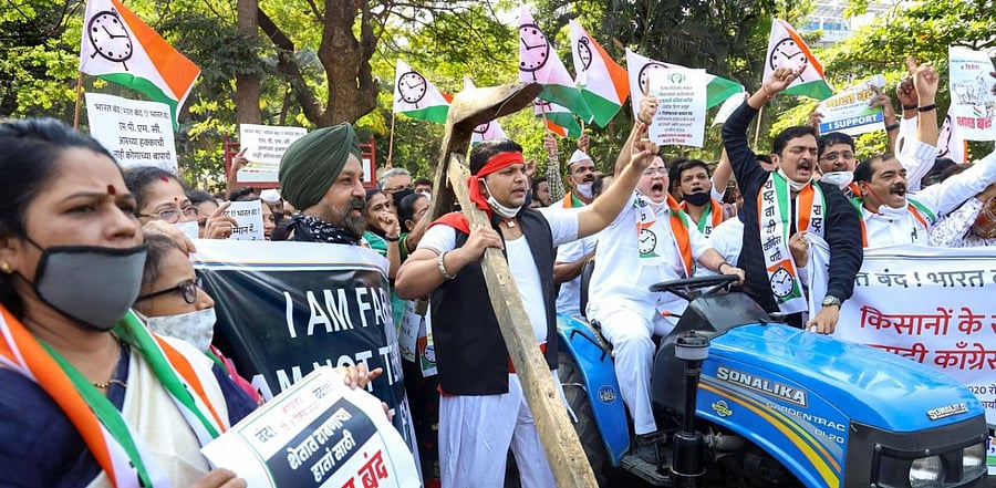 Nationalist Congress Party (NCP) activists stage a protest in support of the nationwide strike, called by farmers to press for repeal of the Centre's Agri laws, outside collector's office in Thane. Credit: PTI Photo