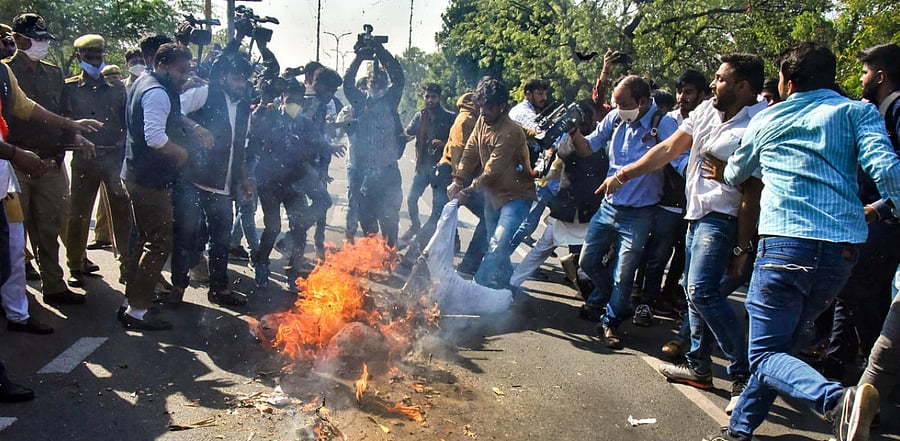 National Students' Union of India (NSUI) activists burn an effigy during a protest in support of the nationwide strike, called by agitating farmers to press for repeal of the Centre's agri-laws, in Jaipur. Credit: PTI Photo