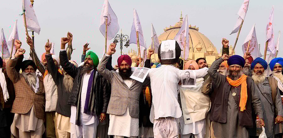 Farmers shout slogans before burning an effigy of India's Prime Minister Narendra Modi, Chairman of Reliance Industries Ltd company Mukesh Ambani and Chairman and Founder of the Adani Group Gautam Adani. Credit: AFP Photo