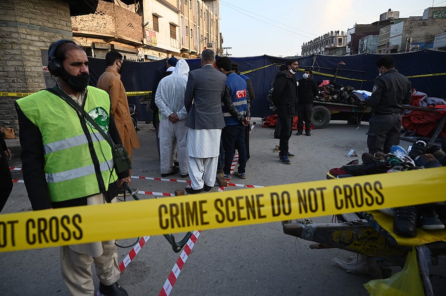 Security officials inspect the site of an explosion at a Ganj Mandi bazar in Rawalpindi. Credit: AFP Photo