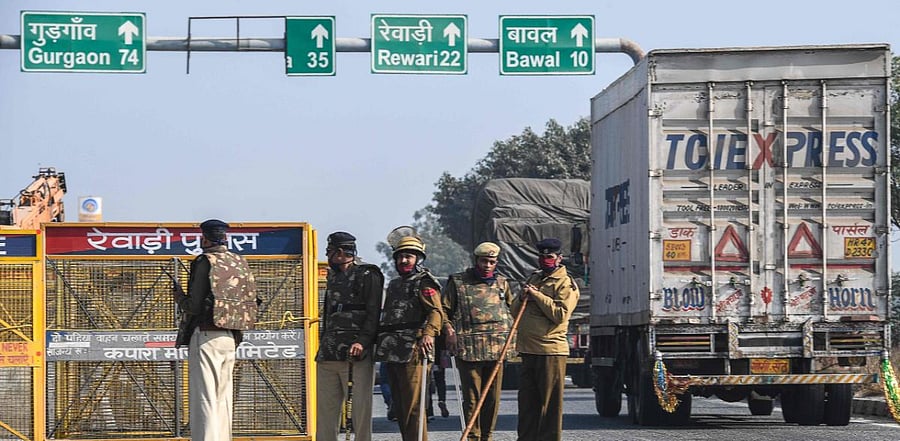 Police personnel stand along a highway on the Haryana-Rajasthan border to stop farmers from joining protests in Delhi against the central government's recent agricultural reforms. Credit: AFP Photo