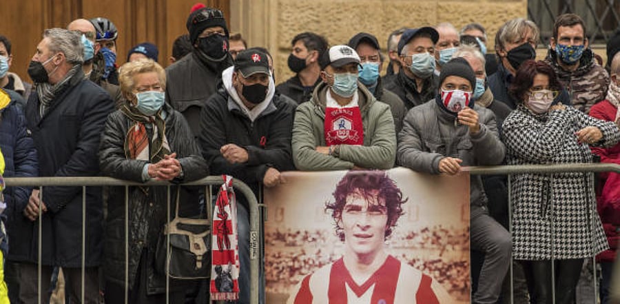 People who were not able to enter the church for the funeral service of Paolo Rossi wait outside, in Vicenza, Italy. Credit: AP/PTI