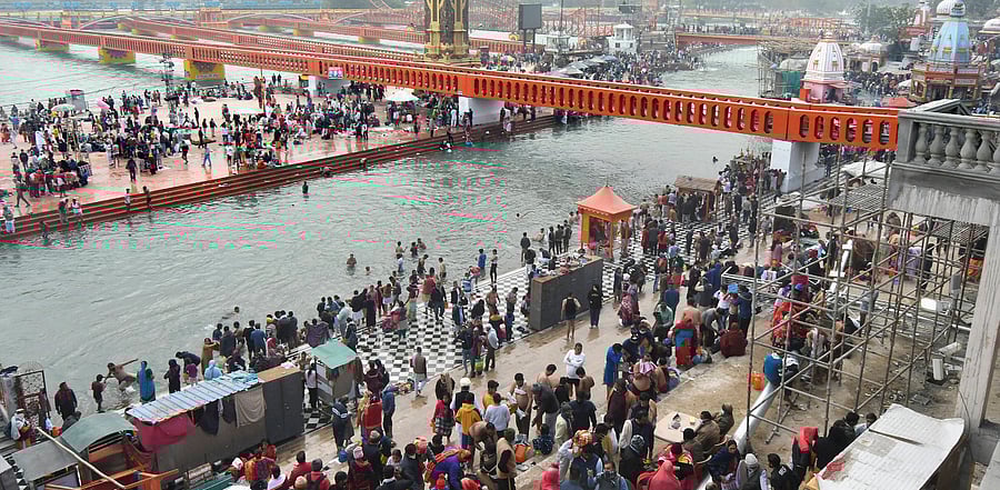 Devotees gather at the banks of River Ganga to take a holy bath, amid the ongoing coronavirus pandemic, in Haridwar. Credit: PTI Photo