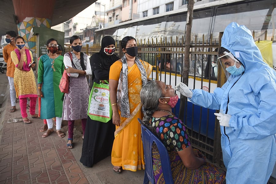Medical Staff collecting nasal swab from public for Coronavirus test. Credit: DH Photo